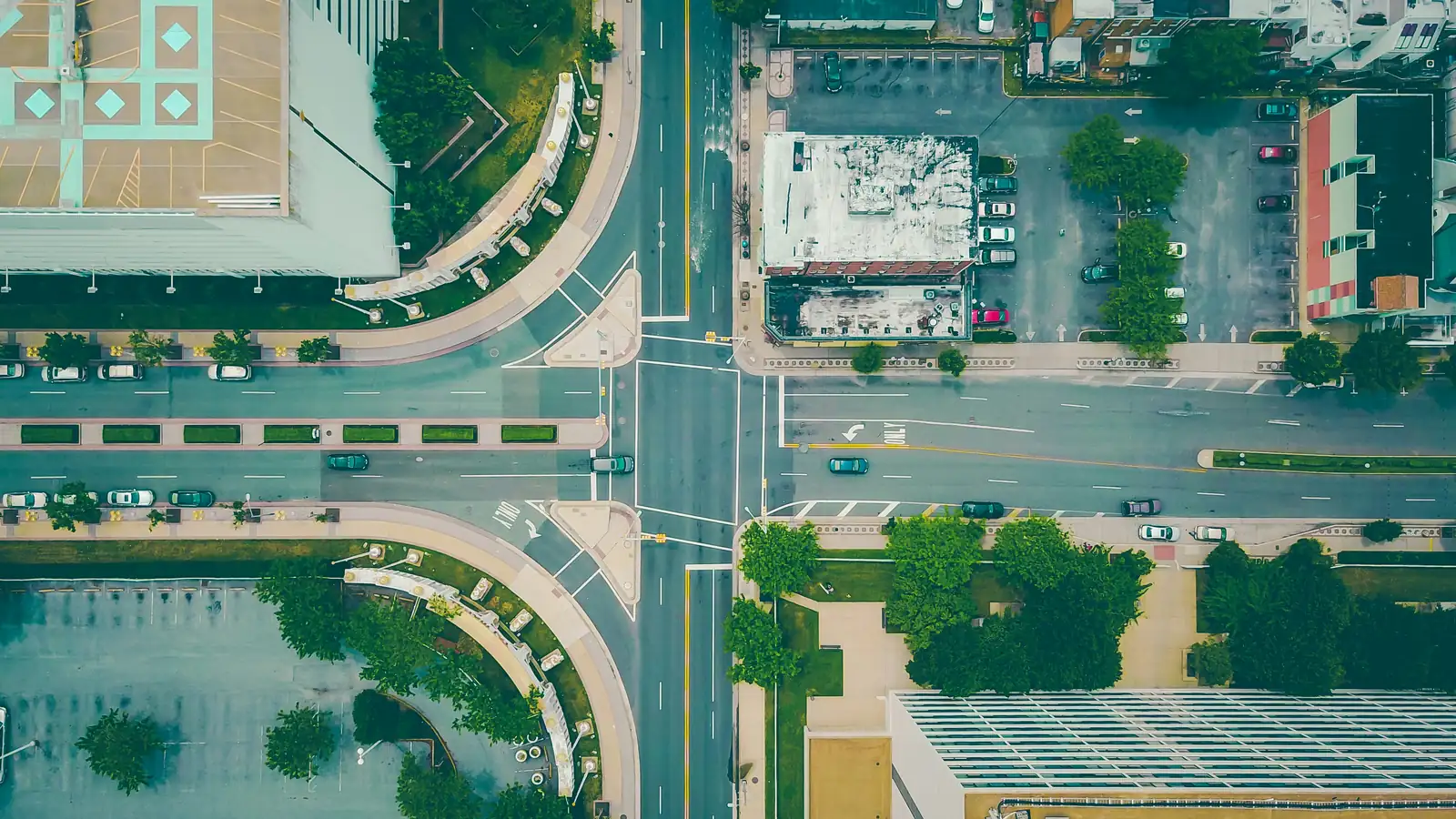 Aerial view of a city street grid with intersecting roads and buildings